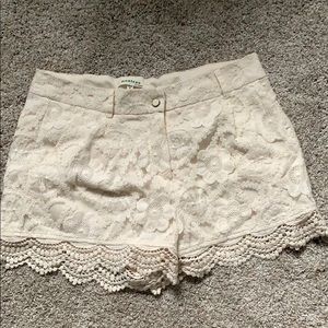 Lace fringed off white shorts